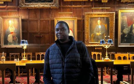 Gibson Ncube in a college dining hall at Oxford